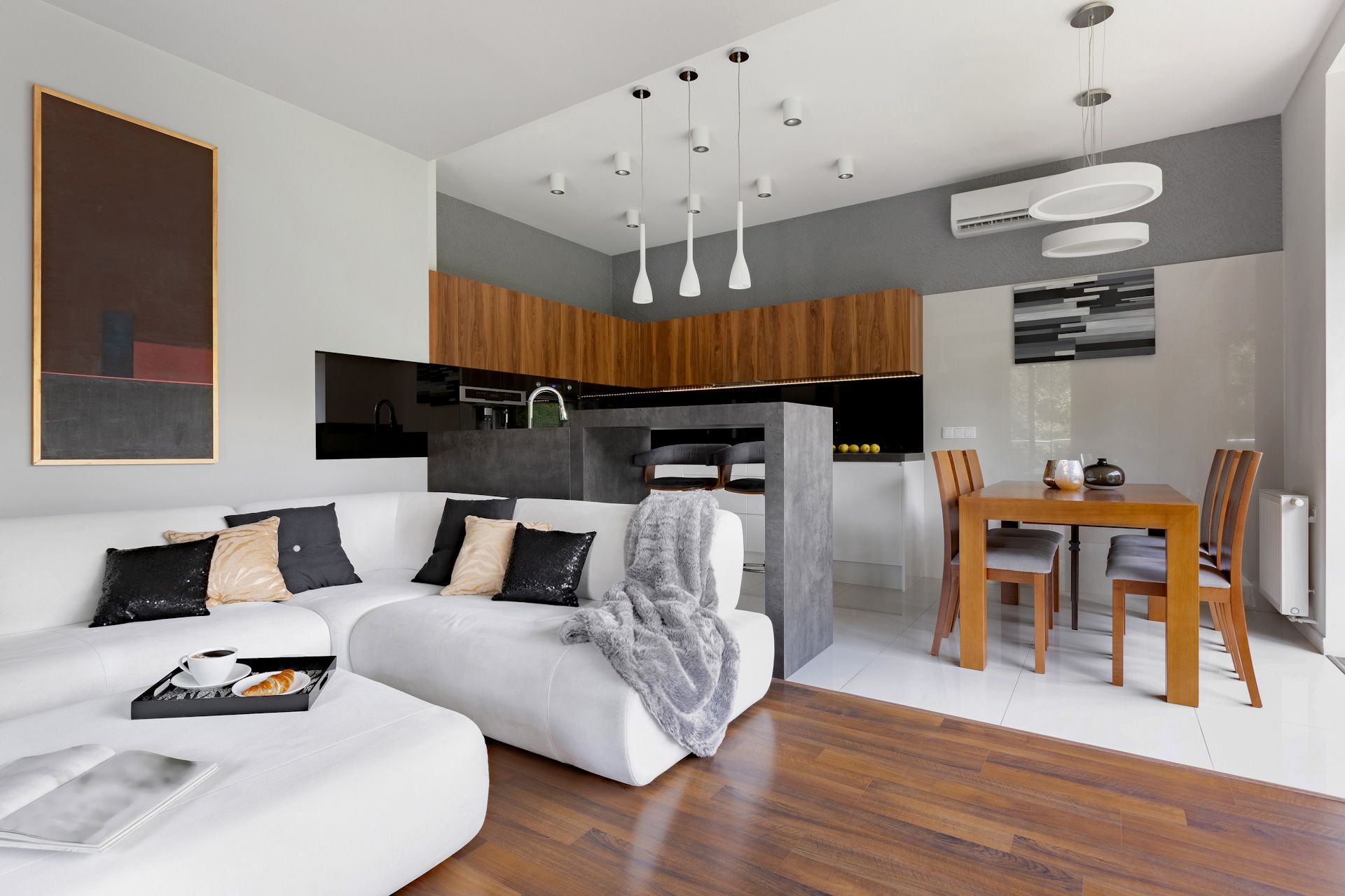 A living room with a white couch and a wooden table.