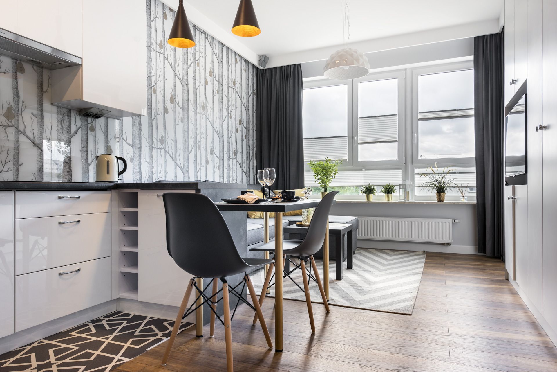 A kitchen with a dining table and chairs in it.