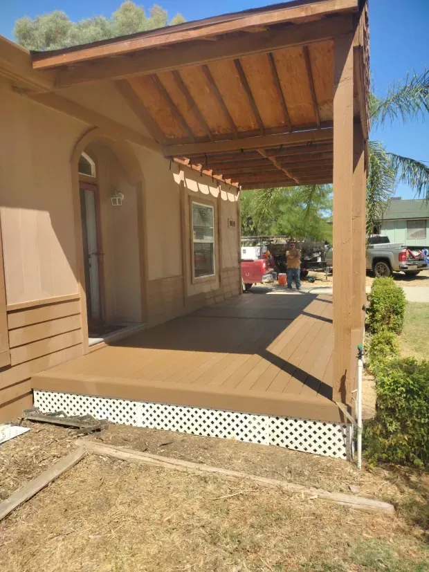 A house with a porch and a truck parked in front of it