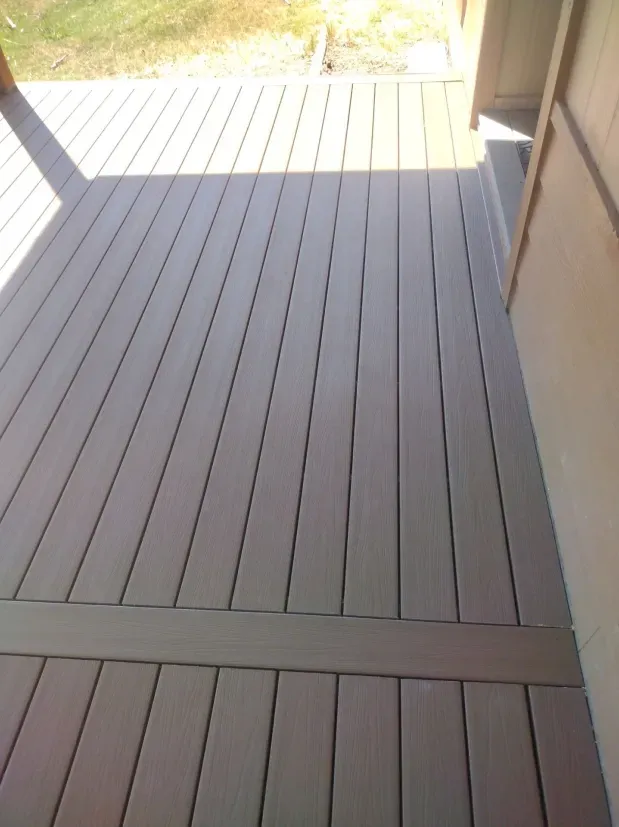 A gray wooden deck with a shadow on it