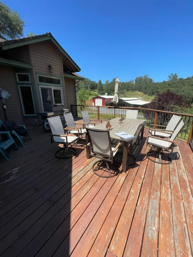 A wooden deck with a table and chairs on it