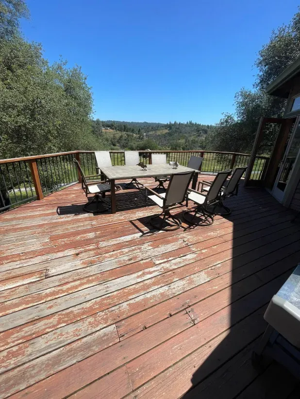 A wooden deck with a table and chairs on it