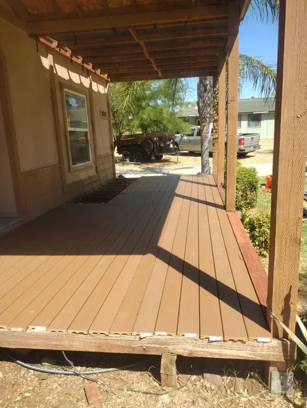 A wooden deck with a pergola on top of it