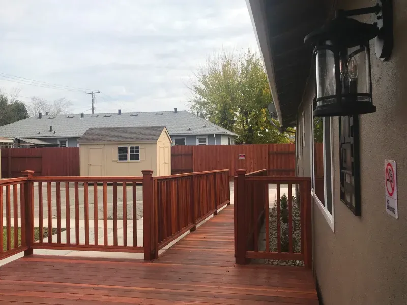 A house with a wooden deck and a sign that says sold