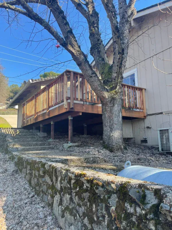 A house with a deck and stairs leading up to it