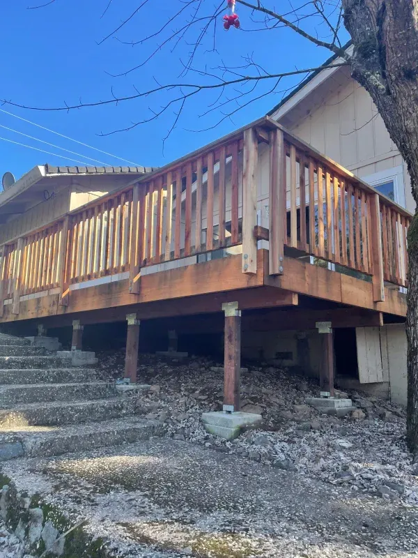 A wooden deck with stairs leading up to it