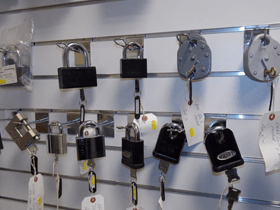 rows of keys and padlocks hung on a wall