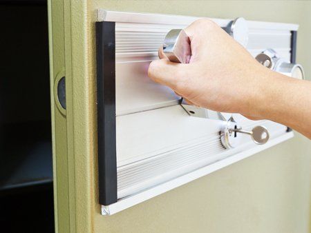 hand opening a safe