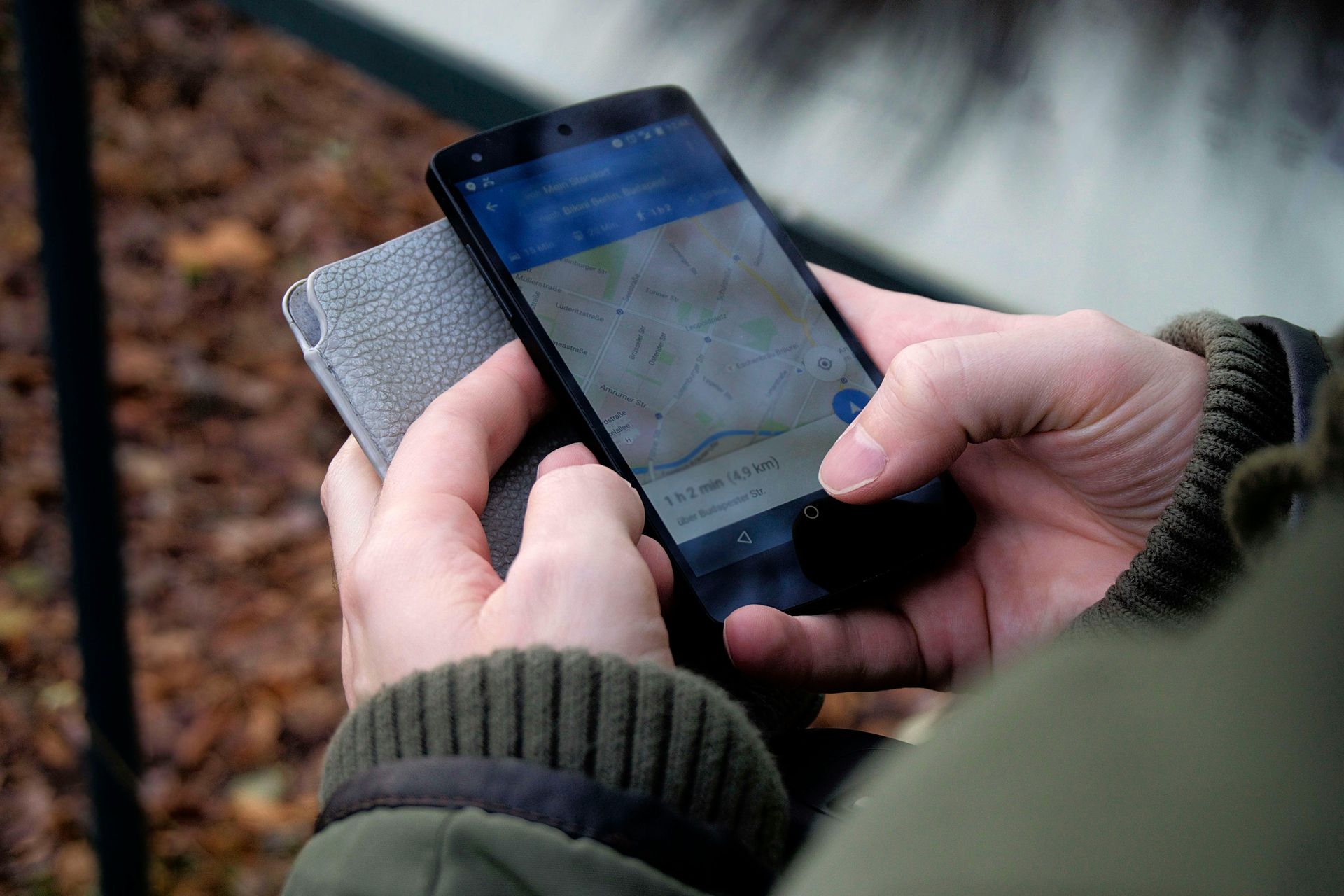 A woman is holding a tablet with a map on it.