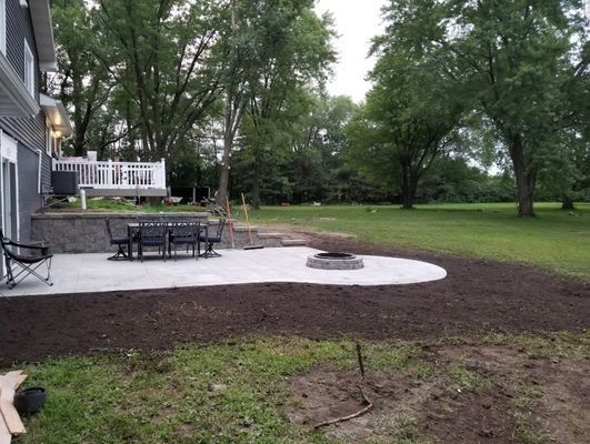 A house with a patio and a fire pit in the backyard
