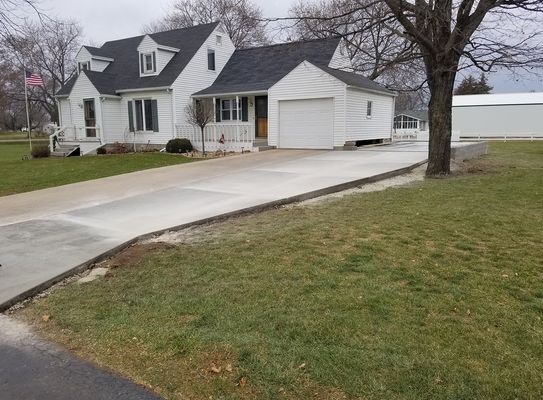 A white house with a driveway leading to it