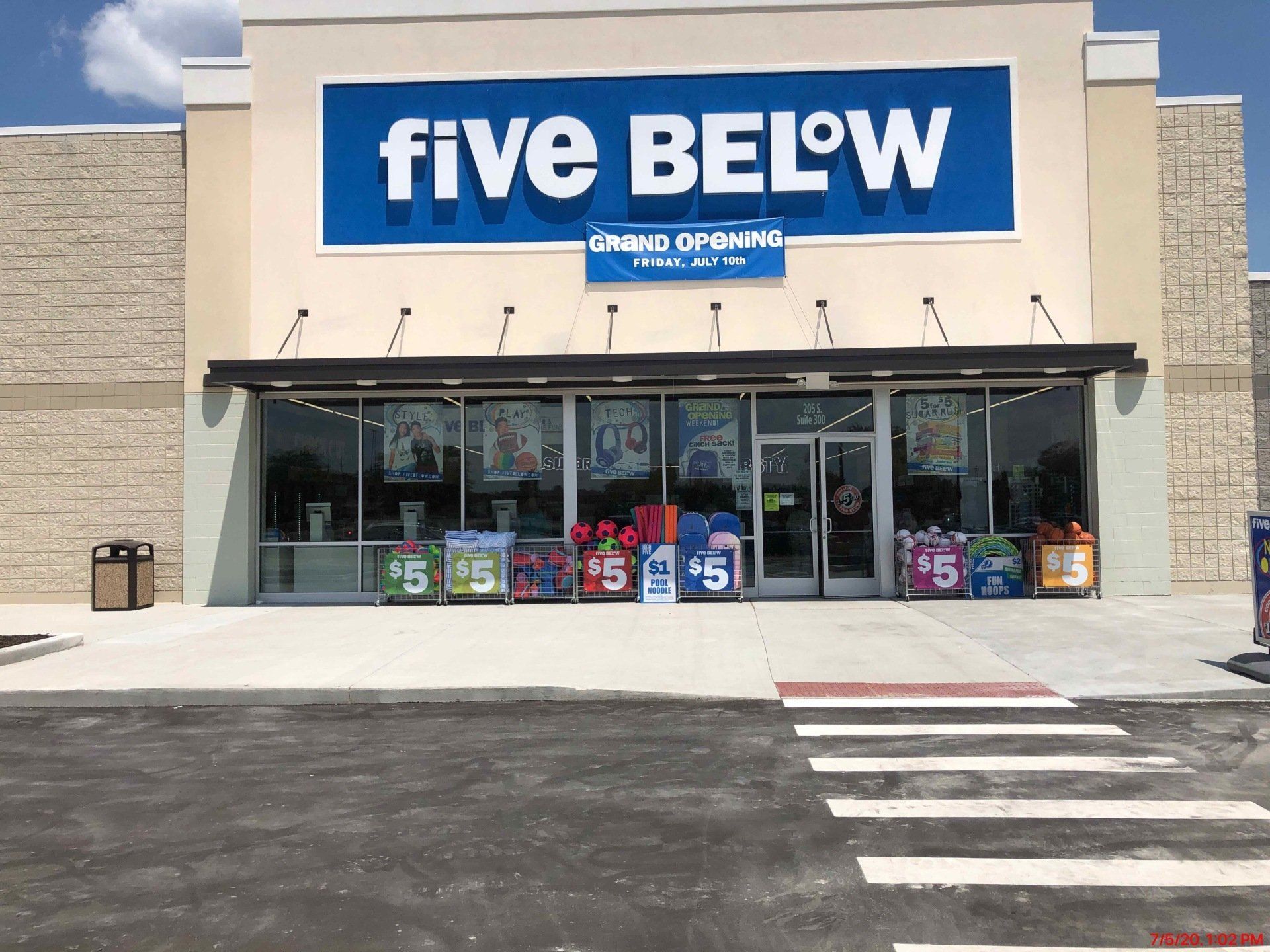 The front of a five below store with a blue sign above the door.