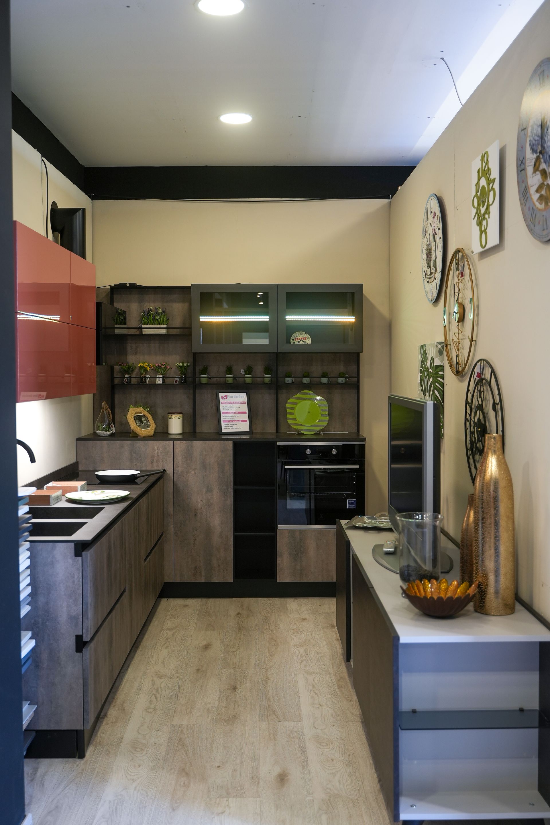 Una cucina con mobili in legno e TV a schermo piatto