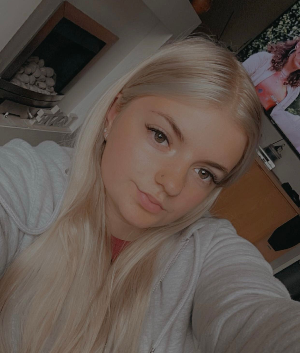 A woman is holding a trophy and a bottle of beer