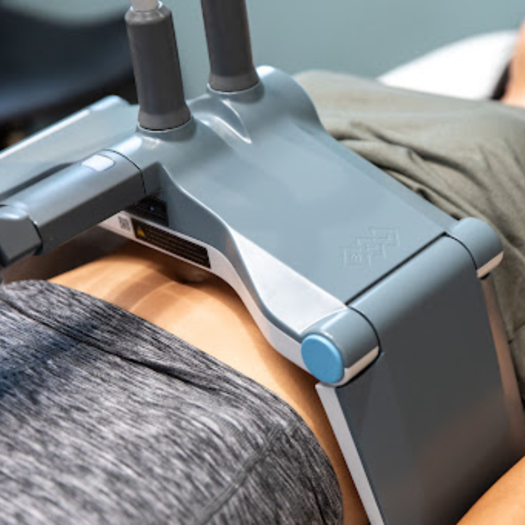 Gray medical device strapped to a patient’s head with two upright antenna-like sensors.