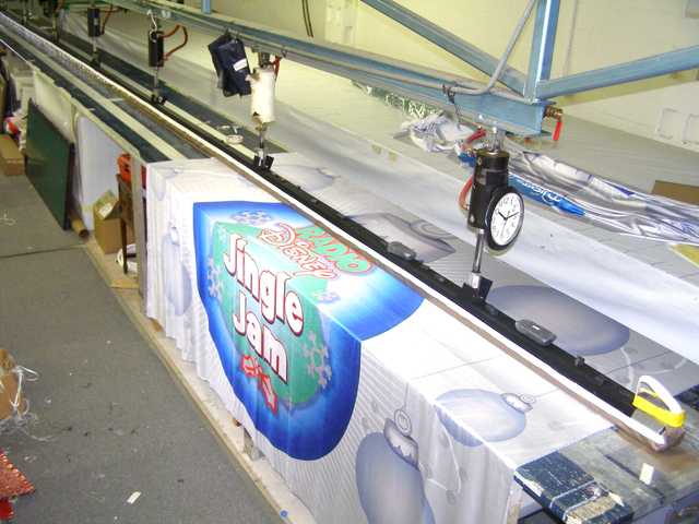 A sign that says jingle jam is on a conveyor belt