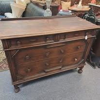 Wooden antique dresser with several drawers, brown finish.