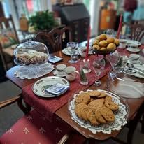 Table set for a meal, with food, plates, and drinks.