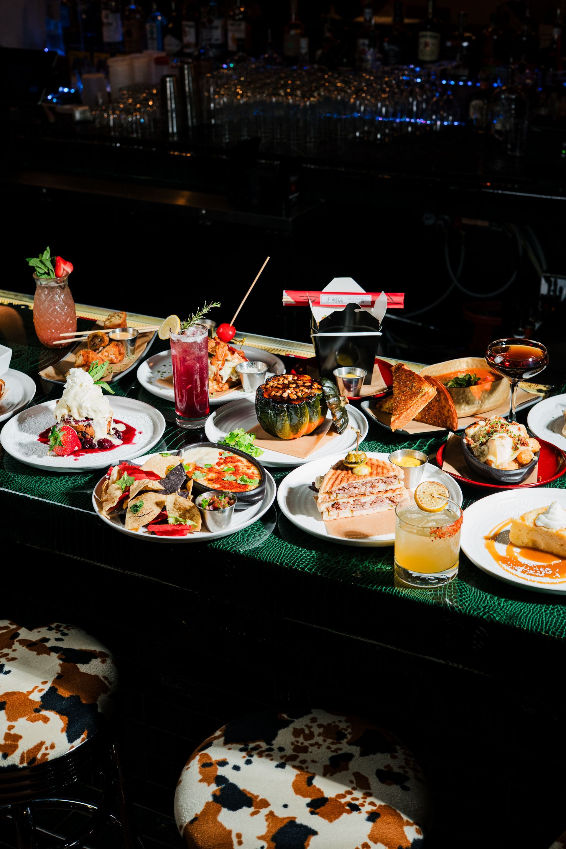Chicken wings with creamy orange sauce on a white rectangular plate.