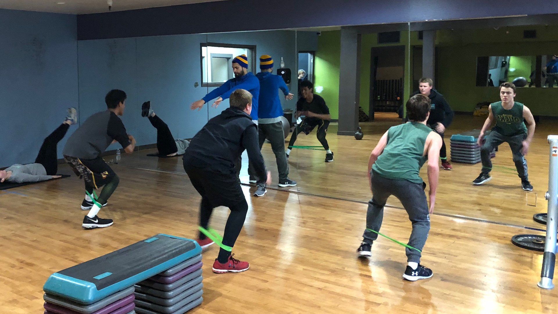 A group of people are doing exercises in a gym.