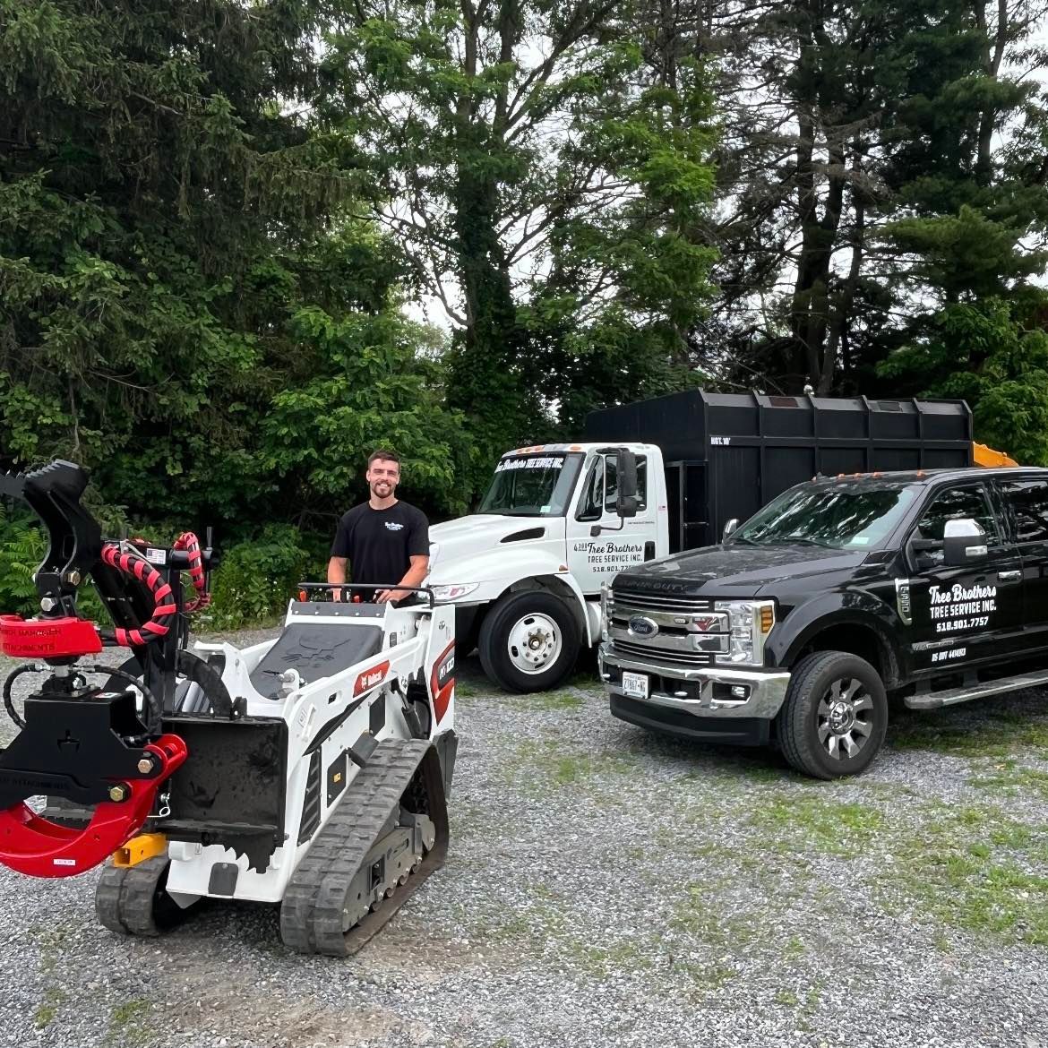 Woman in straw hat smiles, holding wine glass near a lake.