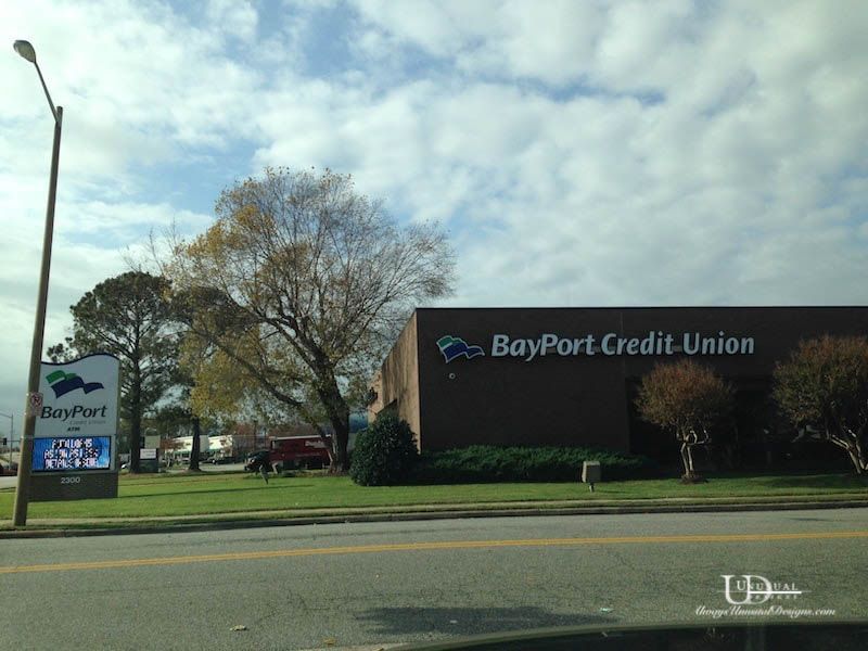 BayPort Credit Union building with sign under cloudy sky.