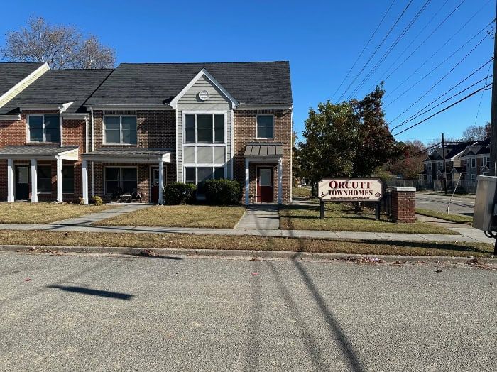 Townhouse apartments with a sign that reads 