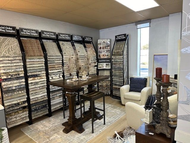 Interior design showroom with samples, table, chairs, and window.