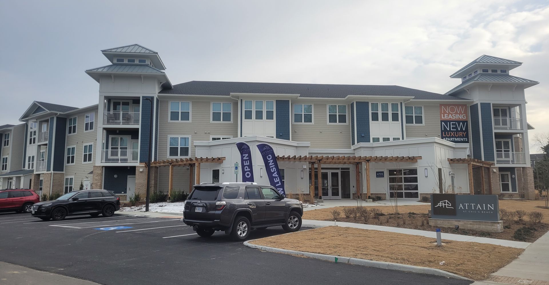 Apartment building exterior, beige stone and blue trim, with 