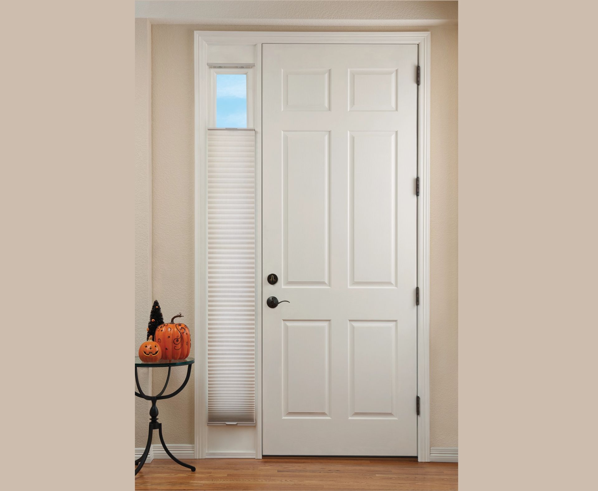 White front door with sidelight and small window; pumpkins and table next to the door.