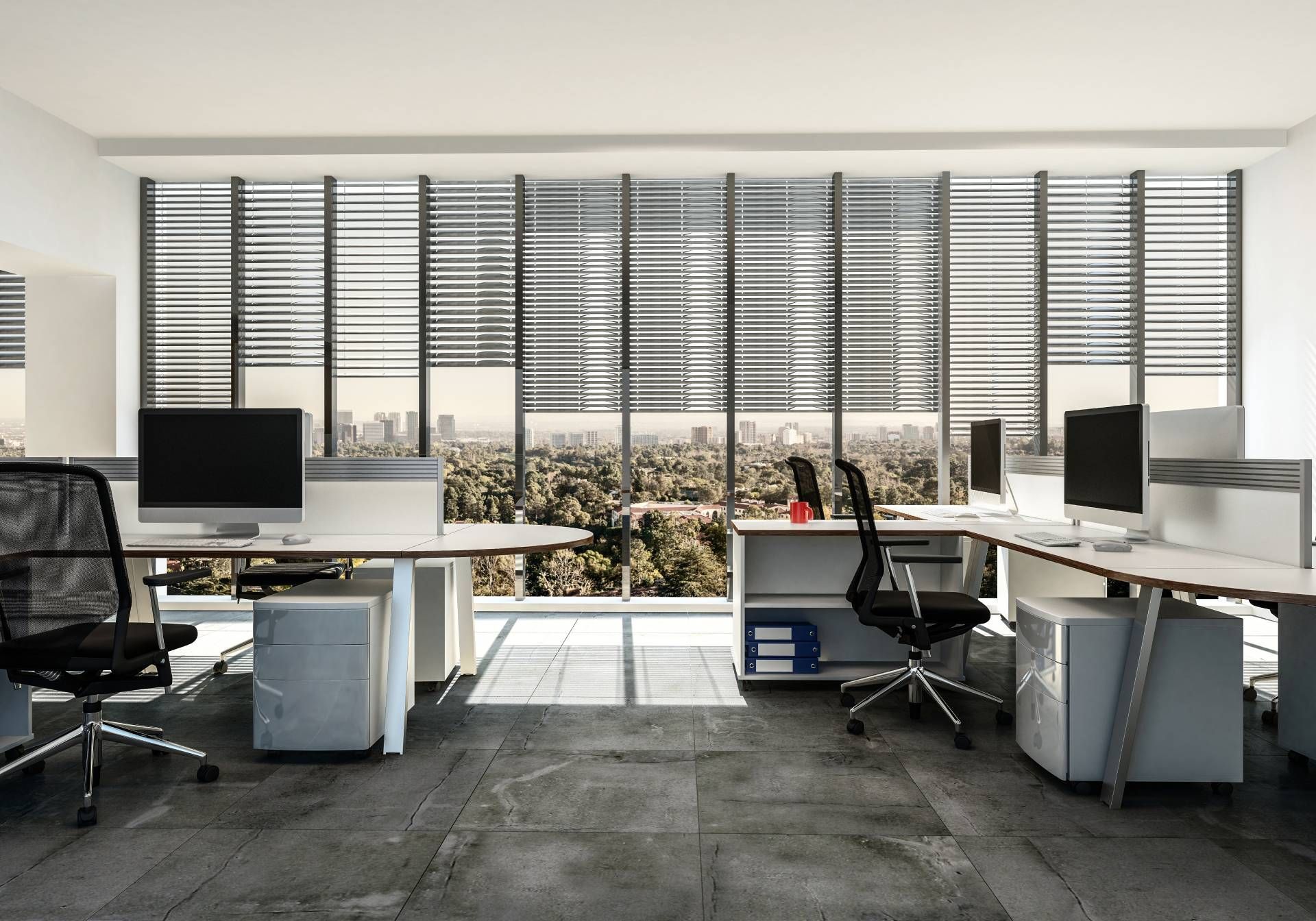 Modern blinds on windows in a commercial office, featuring multiple work stations with computers 