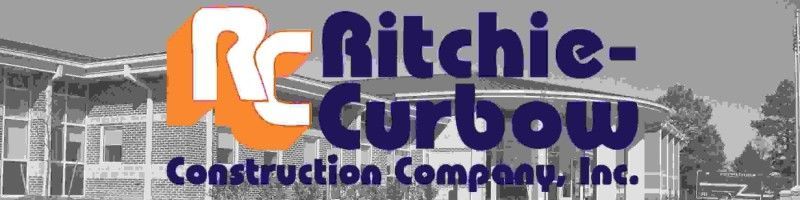 Logo for Ritchie-Curbow Construction Company, Inc. with blue text on a building backdrop.