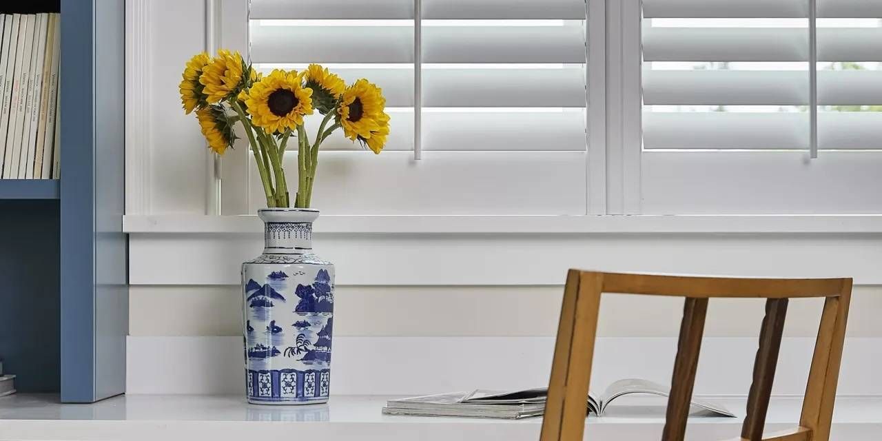 Hunter Douglas NewStyle® Composite Shutters Above a Desk  near Newport News, Virginia (VA)