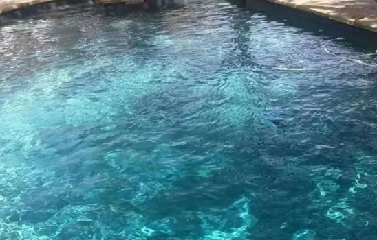 Turquoise water in a pool, rippling in the sunlight.