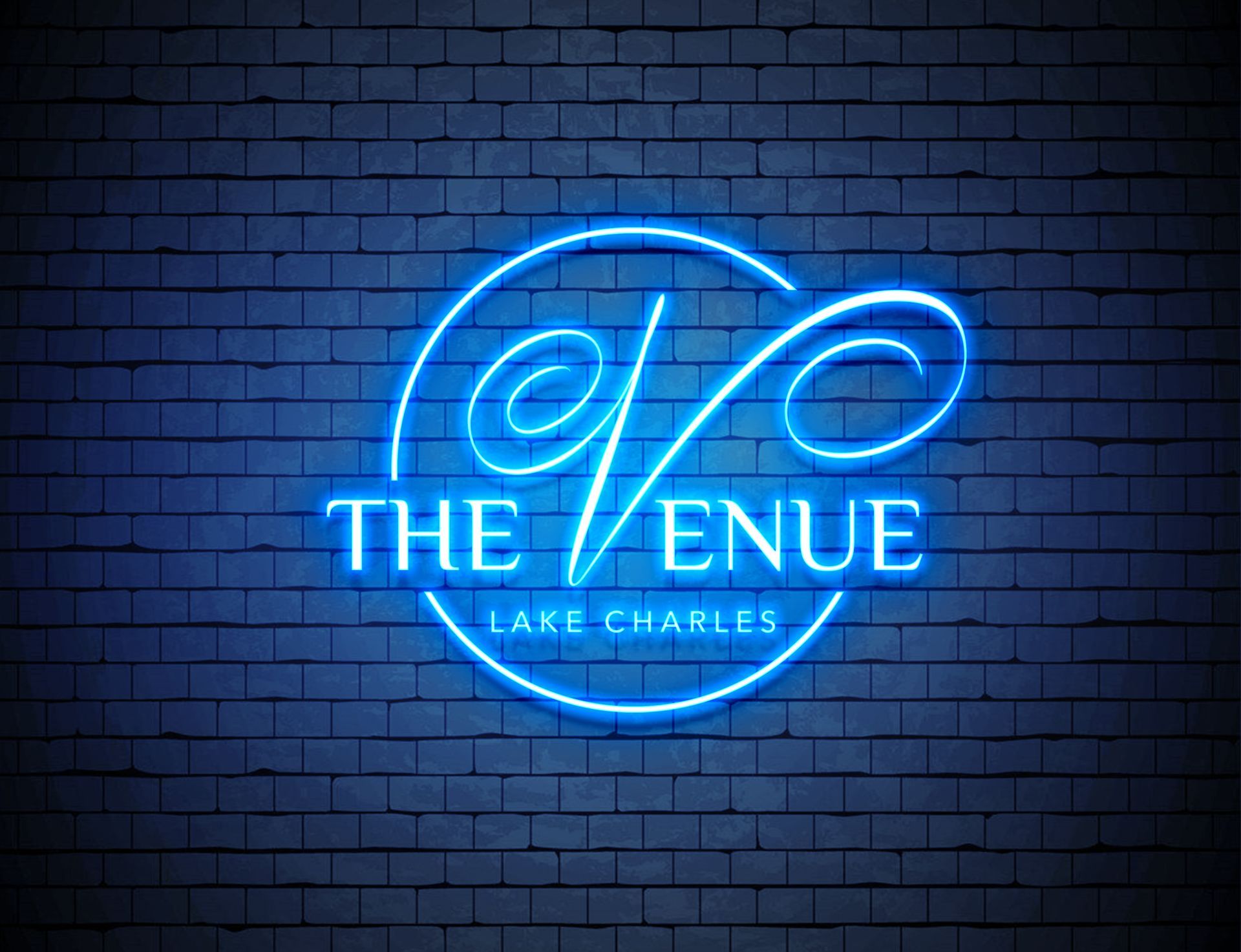 A neon sign for the venue is lit up on a brick wall