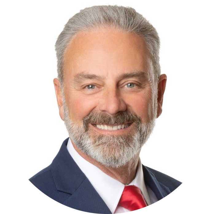 Smiling man in a navy suit and red tie on a white background