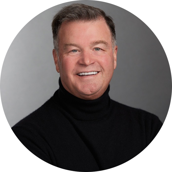 Smiling man in a black turtleneck against a gray background