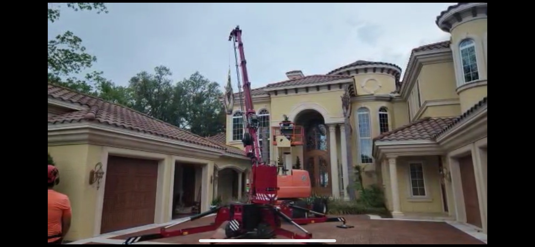 A large house with a crane in front of it.
