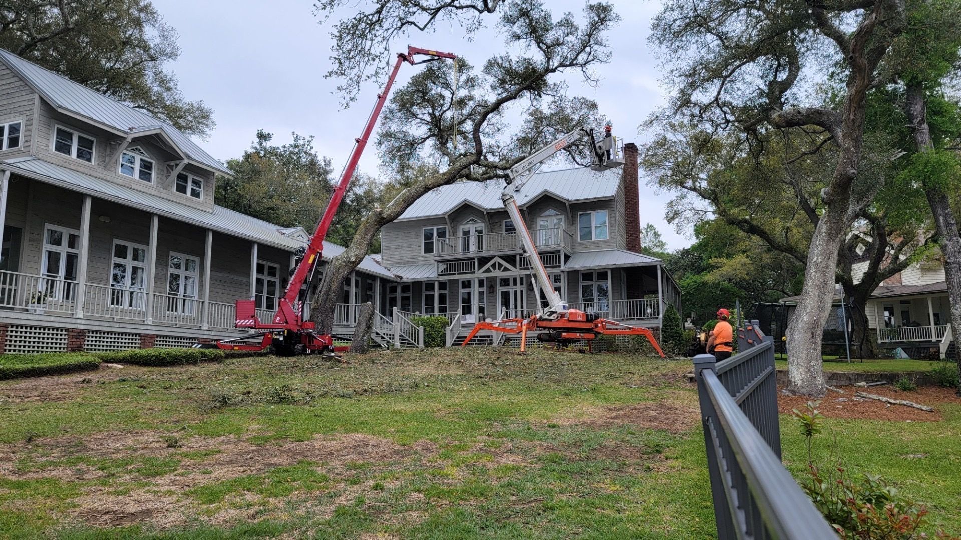 A large house with a crane in front of it.
