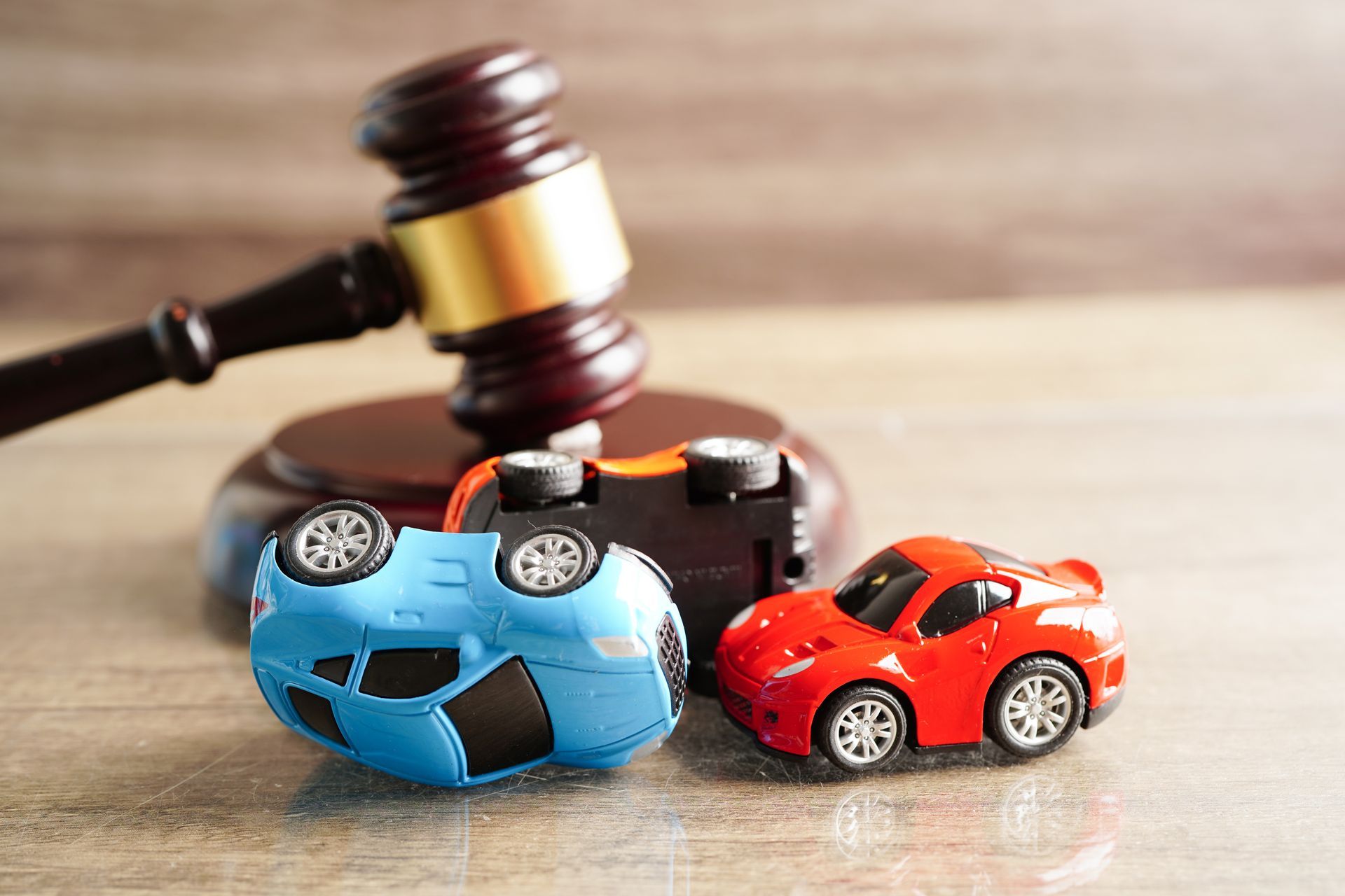 Toy cars in a crash and a gavel.