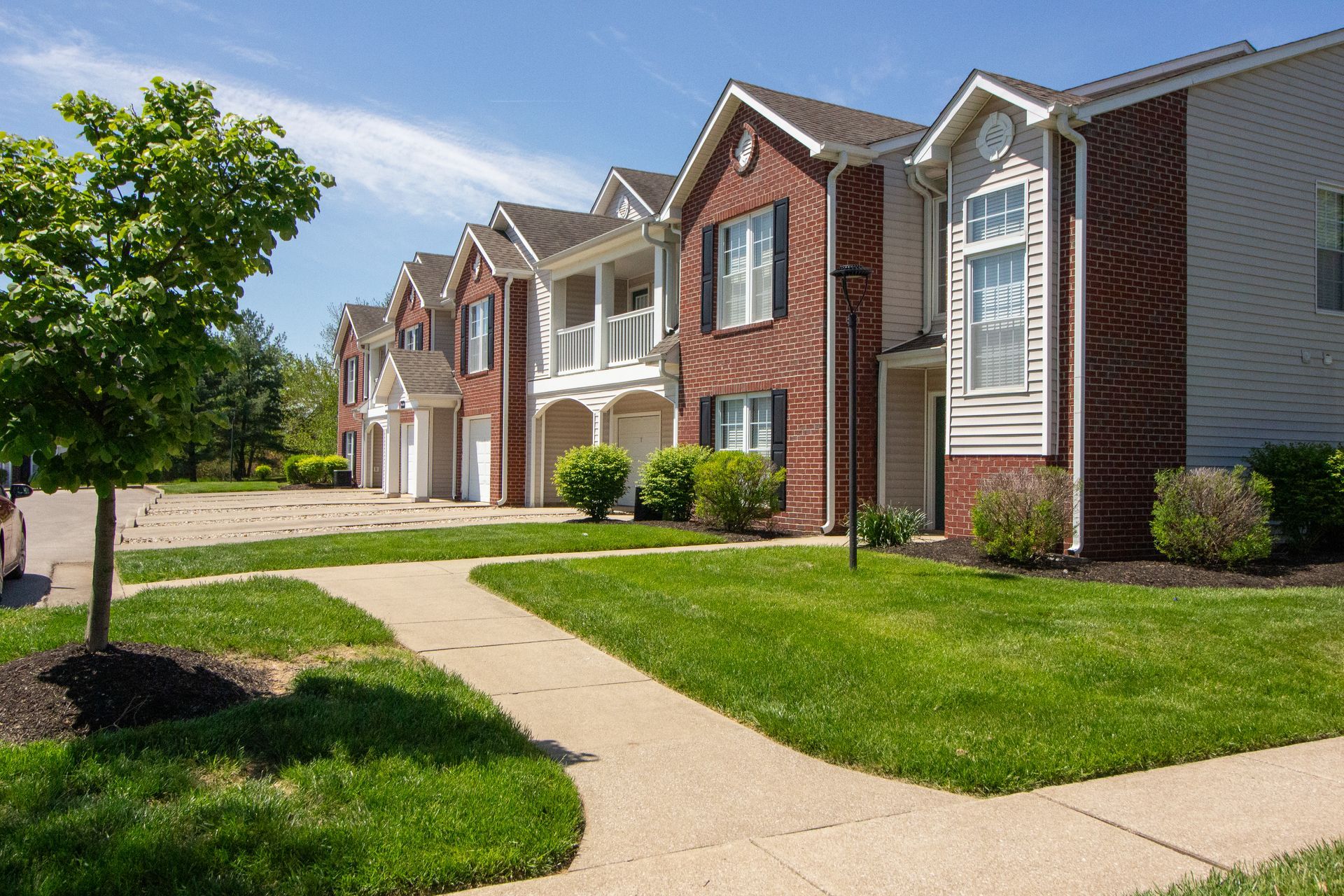 Steeplechase Apartments - Exterior Shot of Building with Sidewalk Leading up and Driveway