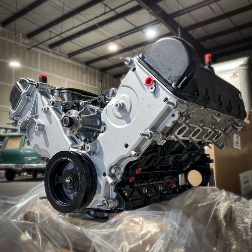 Several classic cars parked inside a garage. A blue Rolls Royce in the foreground, and other vintage cars in the background | Gilroy Car Care