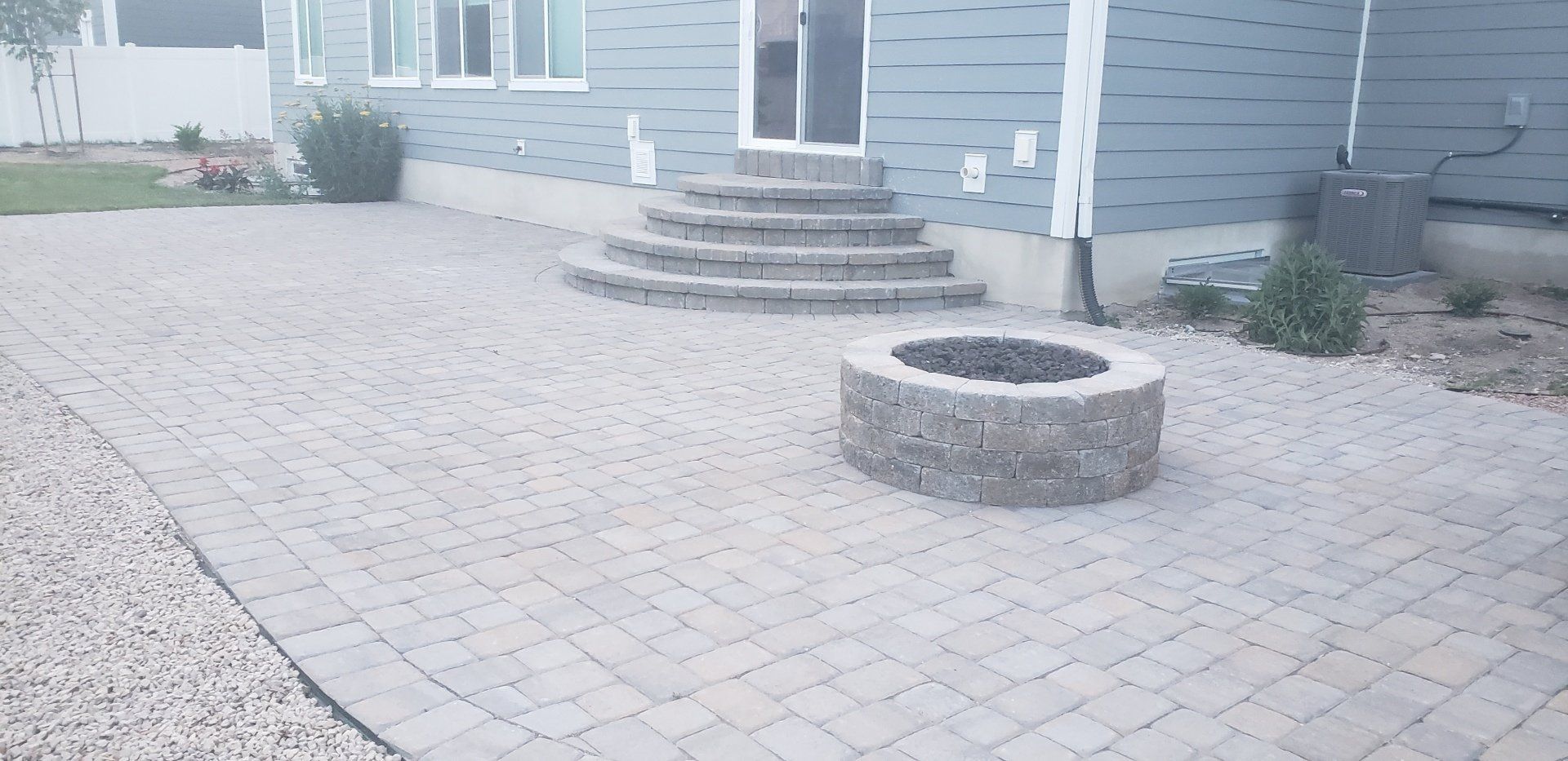 There is a fire pit in the middle of the patio.