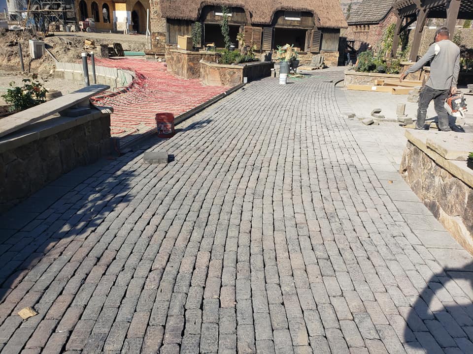 Commercial Pavers — Worker Installing Brick On The Floor In Spanish Fork, UT