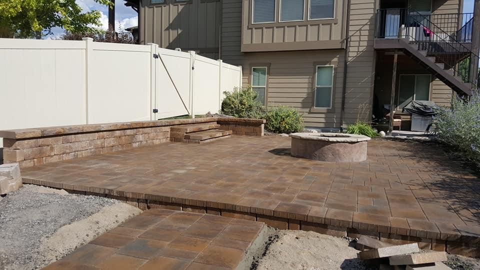 Paver Patio — Paved Patio With A Fireplace In The Middle In Spanish Fork, UT