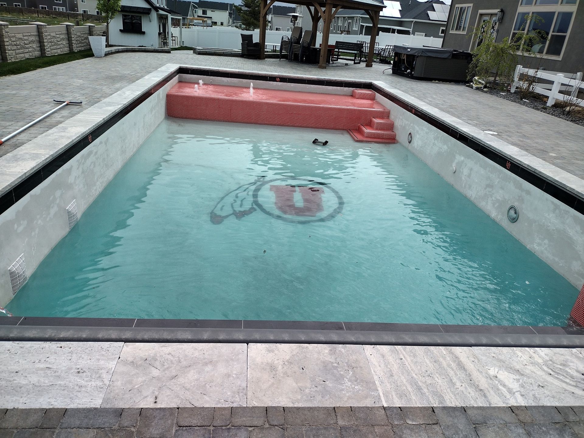 A large swimming pool with a u on the side of it