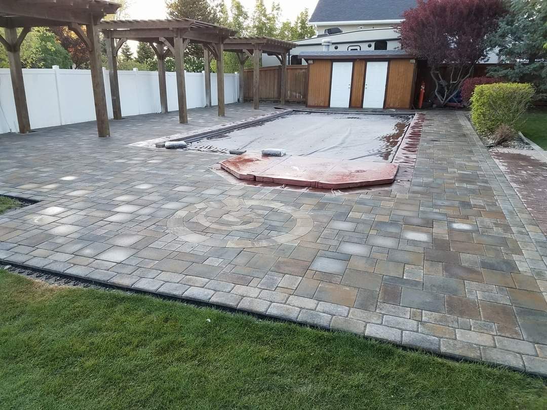 A patio with a swimming pool in the middle of it
