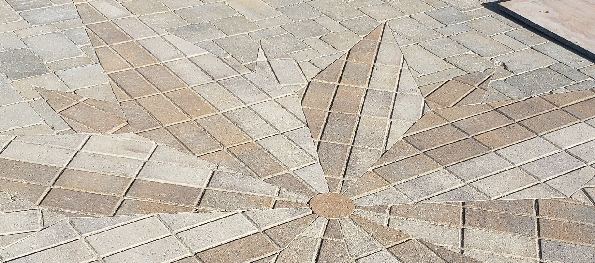 A close up of a brick floor with a pattern on it