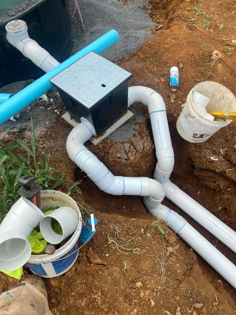 A Bunch of Pipes Are Laying in The Dirt Next to Buckets — Murwillumbah District Plumbing Service in Bilambil, NSW