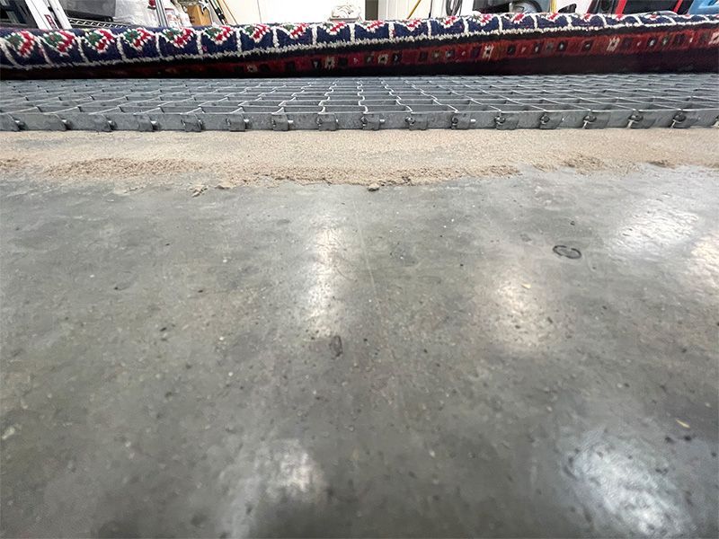 A concrete floor with a metal grate on it
